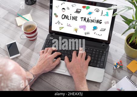 Online training concept shown on a laptop used by a man Stock Photo