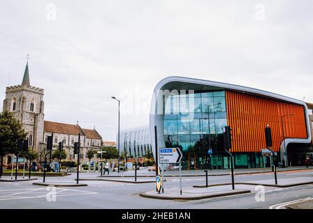 Slough, UK. 10th July, 2021. St Ethelbert's church and the Curve are viewed from the front. The Curve, Slough's £22m library and cultural centre, was Stock Photo