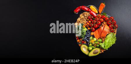 Healthy food arrangement in realistic heart shape, diet for heart and cardiovascular system. Stock Photo