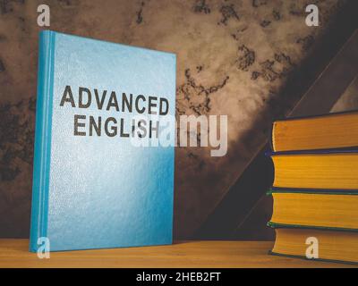 Shelf with book advanced English for learning. Stock Photo