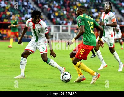 Yaounde, Cameroon. 9th Jan, 2022. Cameroon's Karl Toko Ekambi (front R) vies with Issa Kabore of Burkina Faso during their Group A football match at the Africa Cup of Nations at the Olembe Stadium in Yaounde, Cameroon, Jan. 9, 2022. Credit: Kepseu/Xinhua/Alamy Live News Stock Photo
