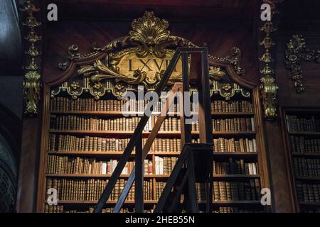 VIENNA, AUSTRIA - MAY 15, 2019: This is a fragment of an antique baroque bookcase in the Austrian National Library. Stock Photo