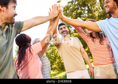 Young people as a startup team give the high five for motivation and team building Stock Photo