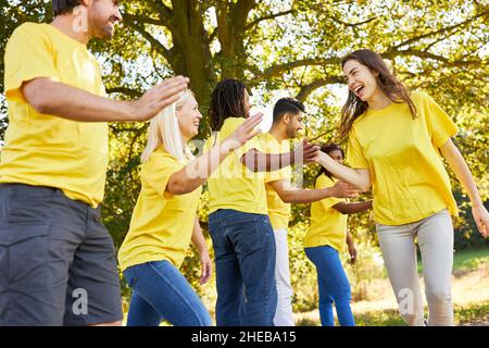 Young people as a successful team are motivated by clapping at the sports event Stock Photo