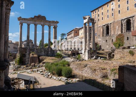 Roman Forum in city of Rome in Italy. Temple of Saturn and Temple of Vespasian and Titus ruins at the western end. Stock Photo