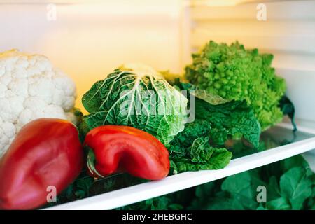 harvest of fresh healthy vegetables on the refrigerator shelf. High quality photo Stock Photo