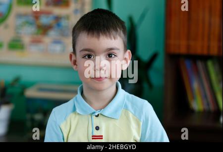 Portrait of a preschooler boy in kindergarten. Stock Photo