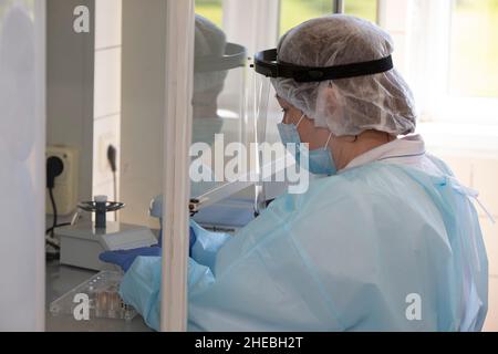 May 31, 2021. Belarus, the city of Gomil. Infectious Diseases Hospital. Doctor laboratory assistant in the infectious diseases laboratory examines the Stock Photo