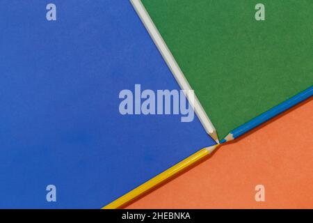 Abstract background from multicolored cardboard separated by different colored pencils Stock Photo