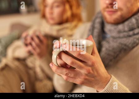 close up of sick young couple drinking tea at home Stock Photo