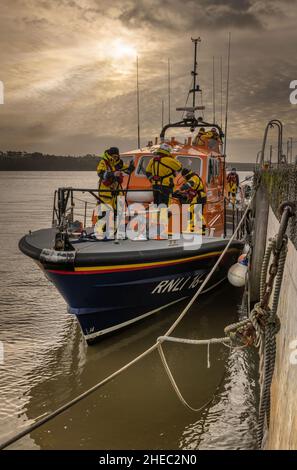 The 'Mollie Hunt', Appledore's Tamar-class lifeboat, moored alongside the quay at Appleore in North Devon whilst her crew finish a Sunday morning trai Stock Photo