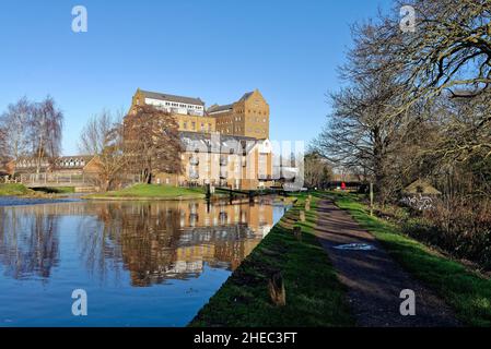 Coxes Lock Mill apartments on the River Wey Navigation canal on a sunny winters day Addlestone Surrey England UK Stock Photo