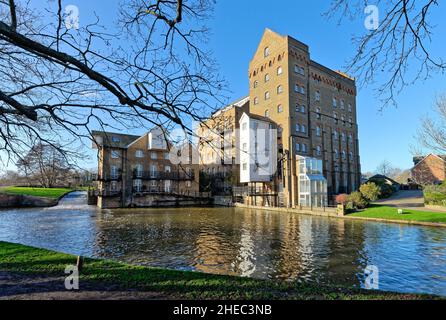 Coxes Lock Mill apartments on the River Wey Navigation canal on a sunny winters day Addlestone Surrey England UK Stock Photo