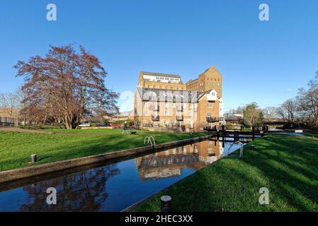 Coxes Lock Mill apartments on the River Wey Navigation canal on a sunny winters day Addlestone Surrey England UK Stock Photo