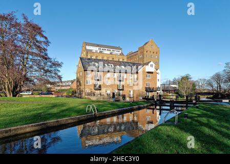 Coxes Lock Mill apartments on the River Wey Navigation canal on a sunny winters day Addlestone Surrey England UK Stock Photo