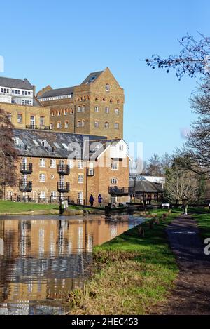 Coxes Lock Mill apartments on the River Wey Navigation canal on a sunny winters day Addlestone Surrey England UK Stock Photo