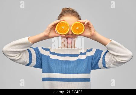 funny teenage girl with oranges instead of eyes Stock Photo