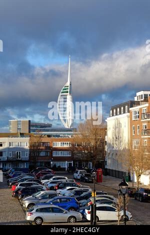 The Spinnaker Tower looming over the skyline of old Portsmouth at Grand Parade  illuminated by a dramatic winter sunset, Hampshire England UK Stock Photo