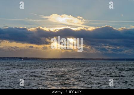 A dramatic winter sky and sunset  across Spithead looking towards the Isle of Wight as viewed from Portsmouth Hampshire England UK Stock Photo