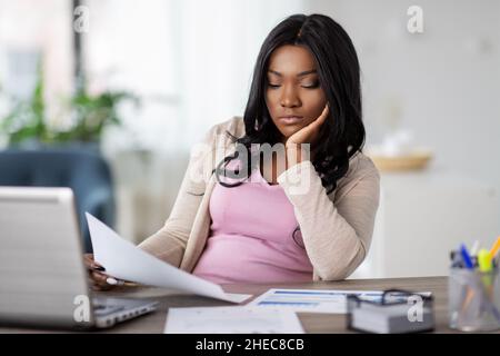 bored woman with papers working at home office Stock Photo