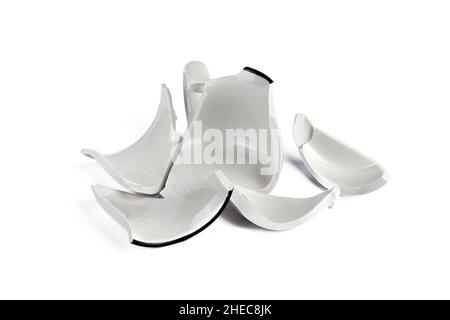 Broken white cup on white background. Concept disintegration, mockup Stock Photo