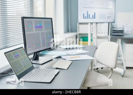 Image of workplace of chemist with laptop and computer with charts on the screen in the laboratory Stock Photo