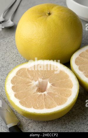 Whole and halved Sweetie citrus fruit close up Stock Photo