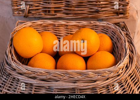 Fresh oranges in a wicker basket Stock Photo