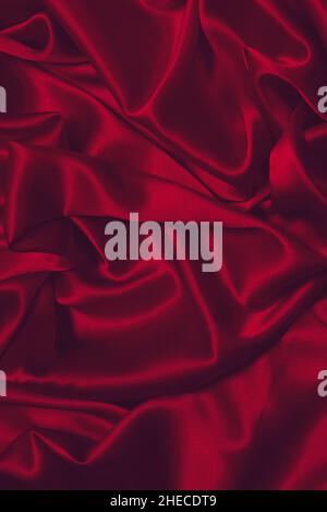 Rich and luxury red silk fabric texture background. Top view. Stock Photo