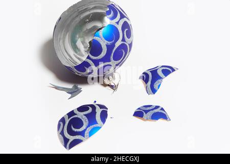 broken blue big Christmas ball. a toy for a Christmas or New Year tree. The concept of the end of the holiday. Stock Photo