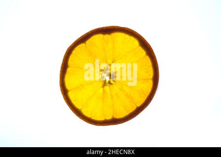 Backlit slice of ripe orange on white background Stock Photo