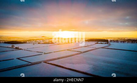 Winter sunset over snowy fields  Stock Photo
