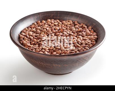 Uncooked lentils in ceramic bowl isolated on white background with clipping path Stock Photo