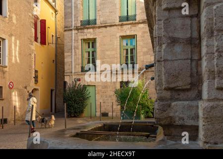 France, Herault, Pezenas, passing through a square with a fountain in the historic center of a southern village Stock Photo