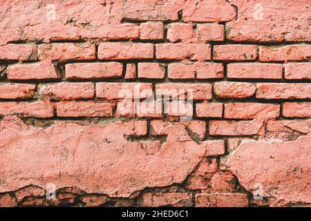 Coral pink painted old brick wall as background, grunge timeworn texture Stock Photo