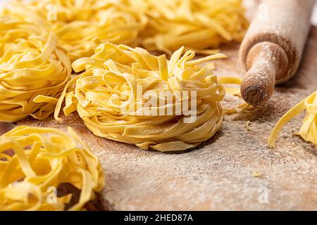 Fresh tagliatelle nests pasta on wood Stock Photo