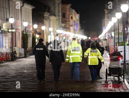 Potsdam, Germany. 10th Jan, 2022. Police officers walk along Brandenburg Street through downtown Potsdam in the early evening. A demonstration against the Corona rules and a counter-demonstration were announced for the evening at the Brandenburg Gate. Credit: Soeren Stache/dpa-Zentralbild/dpa/Alamy Live News Stock Photo