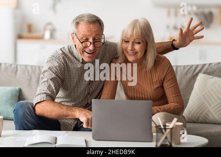 Senior Spouses Making Video Call Talking To Laptop At Home Stock Photo