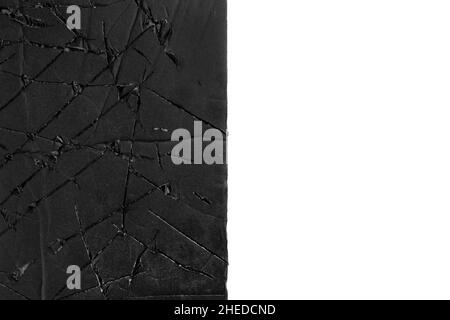 Scratched torn black paper isolated on white. Damaged half background Stock Photo