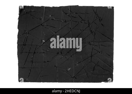 Torn scratched black paper isolated on white background. Grungy rough cracked cardboard Stock Photo
