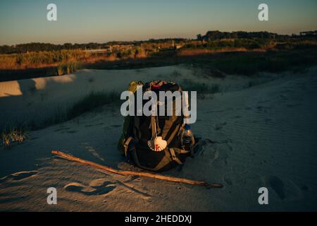 pilgrim's backpack with seashell on the beach Stock Photo - Alamy