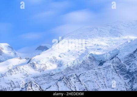 This landscape photo was taken in Europe, in France, in the Alps, towards Chamonix, in the spring. We can see Mont Blanc, under the Sun. Stock Photo