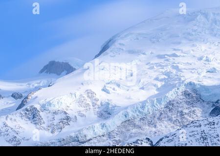 This landscape photo was taken in Europe, in France, in the Alps, towards Chamonix, in the spring. We can see the summit of Mont Blanc, under the Sun. Stock Photo