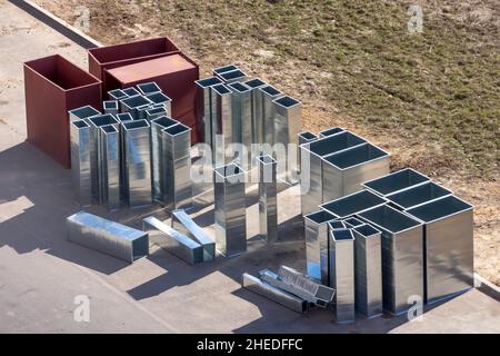 Parts of metal components of the air conditioning system before installation in the building Stock Photo