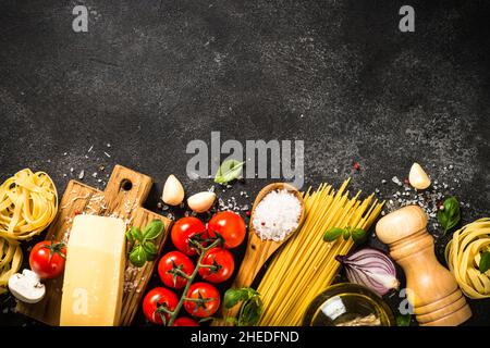 Pasta ingredients on black background top view. Stock Photo