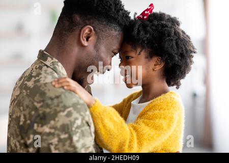 Portrait Of Happy African American Soldier Dad Reunited With His Daughter Stock Photo