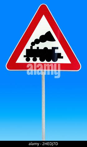 Railroad Level Crossing Sign without barrier or gate ahead the road Stock Photo