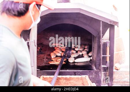 Daily production of bread baked with wood oven with traditional method Stock Photo