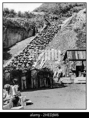 Nazi German death camp Mauthausen-Gusen (1938-1945) in Austria. Prisoners in the quarry (Stairs of Death). Prisoners were forced to carry giant granite boulders in order to supply stones for underground tunnels under Sankt Georgen an der Gusen town; such forced hard labour was like a torture. The American US Army liberated this death camp and shot commandant of the camp Franz Ziereis. Stock Photo