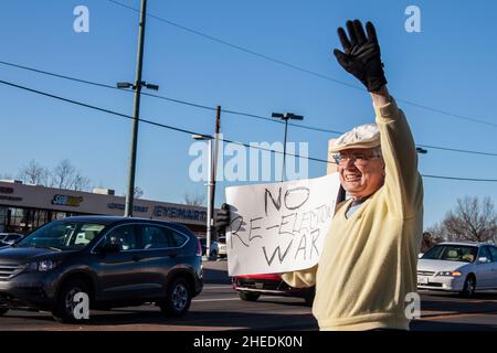 01-04-2020 Tulsa USA - Older man at Iran anti-war protest waving and holding sign saying no re-election war Stock Photo